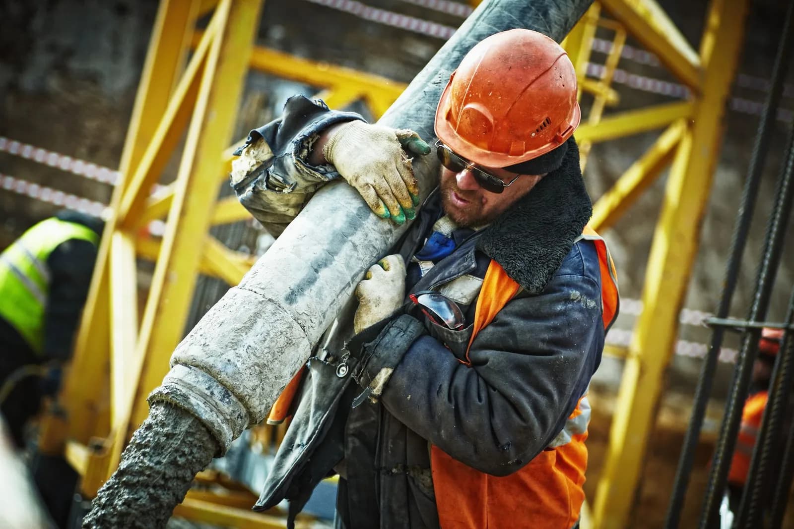 Beton uygulamasını güvenlik ekipmanlarıyla yürüten saha çalışanı